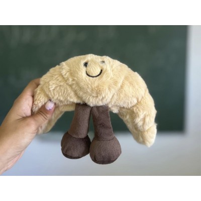 Croissant de peluche sonriente dulce y achuchable